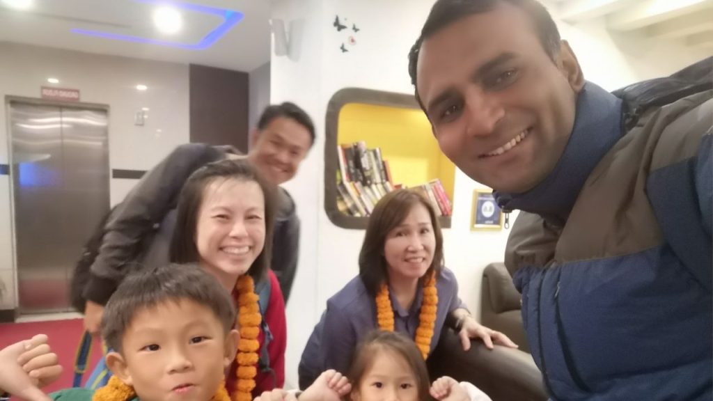 Everest Base Camp Trek with Family begins with a traditional marigold garland welcome in Nepal