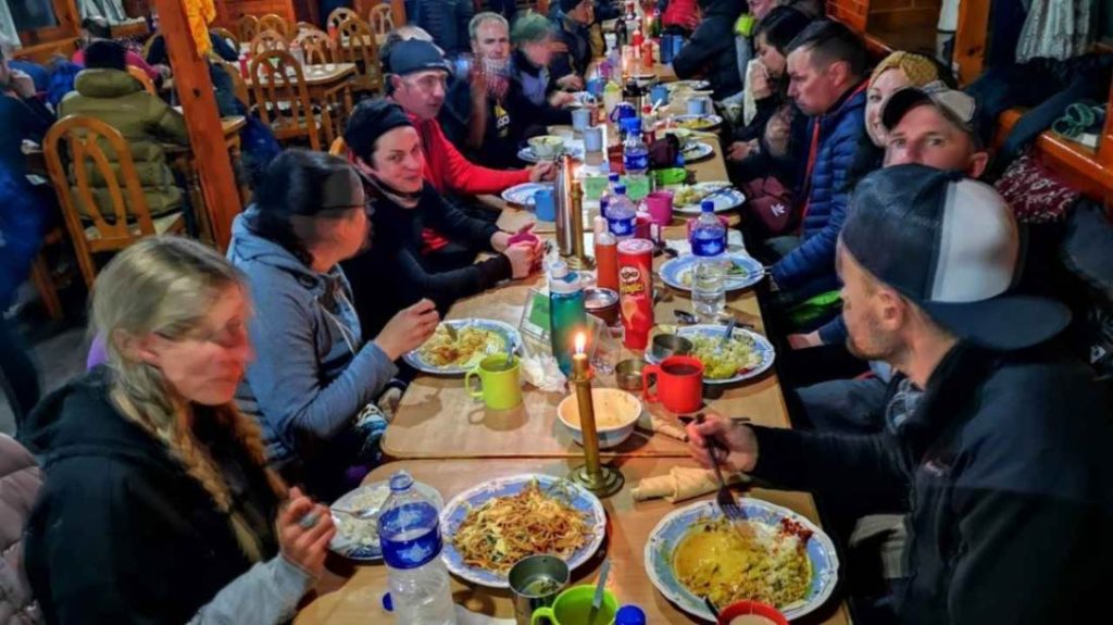 Everest Base Camp Trek Food and Drinks – trekkers eating dinner together at a teahouse table